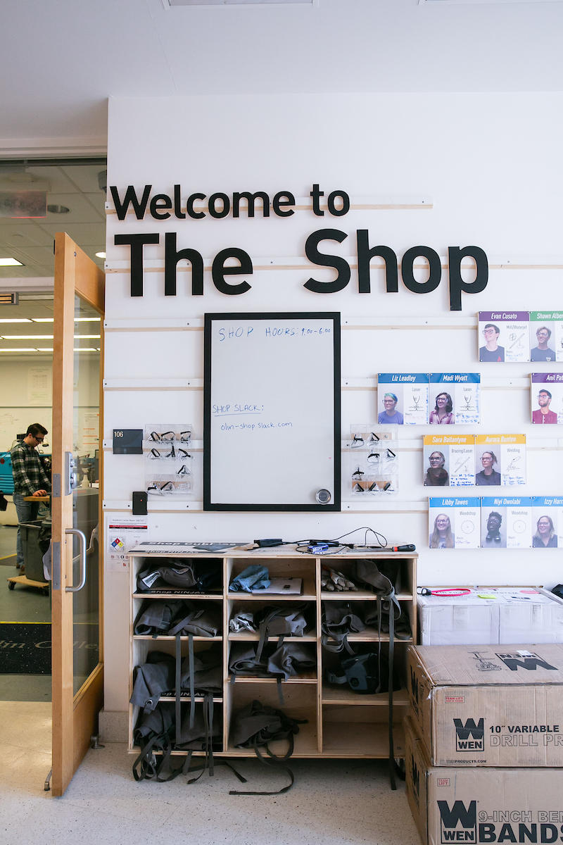 Image of a wall outside the entry the shop with storage bunks and sign on wall representing the facility