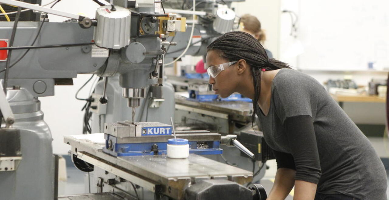Olin student using a shop machine