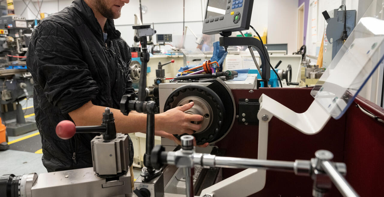 Olin student working on machine 