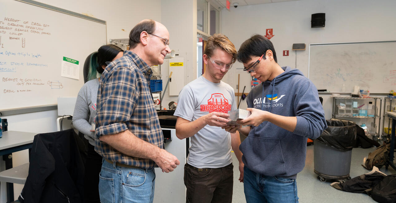Professor working with 2 students