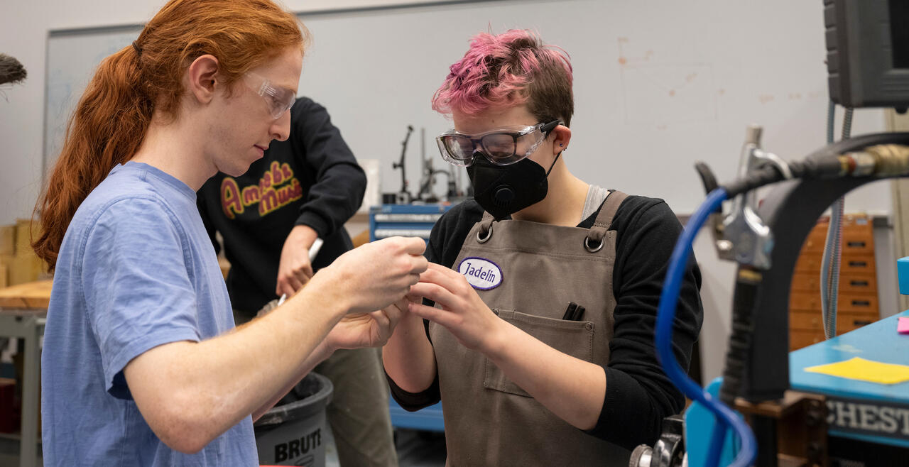 Two students helping each other